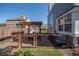 Outdoor space with a pergola-covered patio, dining area, and fenced yard, perfect for entertaining guests at 87 Macon Ct, Aurora, CO 80010