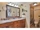 Bathroom with double sinks, granite countertops, and a glass-enclosed shower at 3131 E Alameda Ave # 704, Denver, CO 80209