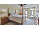 Bedroom featuring a four-poster bed, a ceiling fan, and views of the city skyline at 3131 E Alameda Ave # 704, Denver, CO 80209