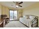 Bright bedroom with ceiling fan and sliding glass doors to private balcony at 3131 E Alameda Ave # 704, Denver, CO 80209