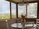 Bright dining area with city views, featuring a round table and stylish chandelier at 3131 E Alameda Ave # 704, Denver, CO 80209