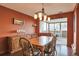 Dining room with a wooden table, decorative lighting, and a view of the city skyline at 3131 E Alameda Ave # 704, Denver, CO 80209