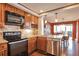 Well-lit kitchen with stainless steel appliances, granite counters, and wood cabinets at 3131 E Alameda Ave # 704, Denver, CO 80209