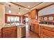 Open-concept kitchen with granite countertops, stainless steel dishwasher, and wood cabinets at 3131 E Alameda Ave # 704, Denver, CO 80209