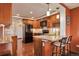 Spacious kitchen with wood cabinets, granite countertops, and a black appliance suite at 3131 E Alameda Ave # 704, Denver, CO 80209