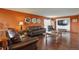 Comfortable living room with hardwood floors, warm paint color, and plenty of seating at 3131 E Alameda Ave # 704, Denver, CO 80209