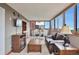Bright living room with beautiful city views, adjacent dining area, and comfortable furnishings at 3131 E Alameda Ave # 704, Denver, CO 80209