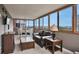 Cozy living room and dining area with walls of windows providing abundant natural light and city views at 3131 E Alameda Ave # 704, Denver, CO 80209