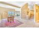 Open basement space with a sitting area, staircase, and large windows at 3221 Autumn Sun Cir, Castle Rock, CO 80104