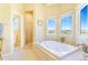 Bright bathroom with a soaking tub, separate glass shower, and scenic views at 3221 Autumn Sun Cir, Castle Rock, CO 80104