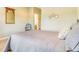 Cozy bedroom featuring neutral tones, a chair, mirror, and view of the bathroom at 3221 Autumn Sun Cir, Castle Rock, CO 80104