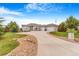 Sprawling ranch home featuring a long driveway, three-car garage, and pristine landscaping at 3221 Autumn Sun Cir, Castle Rock, CO 80104