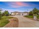 Exterior view of a beautiful home with a circular driveway, three-car garage, and manicured landscaping at 3221 Autumn Sun Cir, Castle Rock, CO 80104