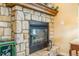 This fireplace has stone surround and a wooden mantle at 3221 Autumn Sun Cir, Castle Rock, CO 80104