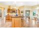 The kitchen has wood cabinets and a butcher block island with breakfast bar at 3221 Autumn Sun Cir, Castle Rock, CO 80104