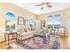 This living room offers large windows with beautiful scenic views and elegant decor at 3221 Autumn Sun Cir, Castle Rock, CO 80104