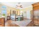 Bright bedroom featuring a decorative trunk, four-poster bed, wooden floors and natural light at 3221 Autumn Sun Cir, Castle Rock, CO 80104