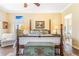 Bright bedroom featuring a decorative trunk, four-poster bed, and ample natural light at 3221 Autumn Sun Cir, Castle Rock, CO 80104
