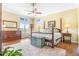 Bedroom with a four-poster bed, wood floors, and a decorative trunk at the end of the bed at 3221 Autumn Sun Cir, Castle Rock, CO 80104