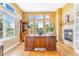 Office with hardwood floors, large windows, a fireplace, and custom built-ins at 3221 Autumn Sun Cir, Castle Rock, CO 80104