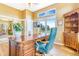 Office with hardwood floors, large windows, and a high-end executive desk at 3221 Autumn Sun Cir, Castle Rock, CO 80104