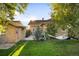 Large backyard with a patio, an outdoor dining area, hammock, lush lawn, and privacy fence at 2026 S Lincoln St, Denver, CO 80210
