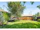 Lush backyard featuring mature trees, a wooden fence, and verdant lawn at 2026 S Lincoln St, Denver, CO 80210