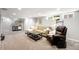 Carpeted basement area features a cozy seating area with an additional leather chair at 2026 S Lincoln St, Denver, CO 80210