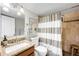 Updated bathroom with a granite vanity, stylish fixtures, and tiled shower/tub combo at 2026 S Lincoln St, Denver, CO 80210