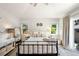 Bright bedroom with a ceiling fan, a comfortable bed, and access to the outdoors at 2026 S Lincoln St, Denver, CO 80210