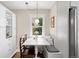 Charming breakfast nook featuring a cozy bench, wooden chairs, and bright natural light at 2026 S Lincoln St, Denver, CO 80210
