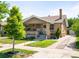 Charming brick home with a well-manicured front yard and a long driveway at 2026 S Lincoln St, Denver, CO 80210