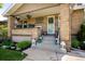 Charming brick home with a cozy front porch, decorative plants, and welcoming entrance at 2026 S Lincoln St, Denver, CO 80210