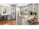 Bright kitchen with stainless steel appliances, a breakfast bar, and a cozy dining nook, perfect for modern living at 2026 S Lincoln St, Denver, CO 80210