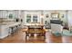 Living room seamlessly connects to dining area and kitchen with hardwood floors and ample natural light at 2026 S Lincoln St, Denver, CO 80210