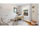 Cozy home office with a small desk, a comfortable chair, and natural light from the window at 2026 S Lincoln St, Denver, CO 80210