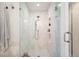 Modern walk-in shower featuring white tiles, dual shower heads, and glass doors at 2026 S Lincoln St, Denver, CO 80210