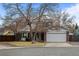 Charming two-story home with brick facade, mature trees, and a two-car garage in a residential neighborhood at 9560 W 104Th Ave, Broomfield, CO 80021