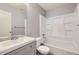 Well-lit bathroom featuring a gray vanity and a shower and bathtub combo at 9605 Elk Mountain Cir, Littleton, CO 80125