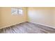 Bedroom with a window providing natural light, neutral colored walls and vinyl flooring at 9605 Elk Mountain Cir, Littleton, CO 80125