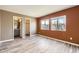 Spacious primary bedroom with warm, neutral tones, vinyl plank flooring, and large double windows at 9605 Elk Mountain Cir, Littleton, CO 80125