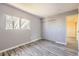 Inviting bedroom with gray vinyl floors, a double window, closet and an entry door to the hallway at 9605 Elk Mountain Cir, Littleton, CO 80125