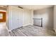 Bedroom with wood-look floors, a spacious closet, and a staircase landing at 9605 Elk Mountain Cir, Littleton, CO 80125