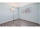 Light and airy bedroom with blue walls, two windows, and wood-look flooring at 9605 Elk Mountain Cir, Littleton, CO 80125