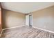 Neutral bedroom with vinyl plank flooring, a door to the hallway, and large windows at 9605 Elk Mountain Cir, Littleton, CO 80125