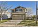 Two-story home with a two-car garage, blue shutters, and a well-manicured lawn at 9605 Elk Mountain Cir, Littleton, CO 80125