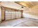 Spacious two-car garage with an automatic door and a clean concrete floor at 9605 Elk Mountain Cir, Littleton, CO 80125