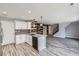 Eat-in kitchen features white cabinets, an island, and stainless steel appliances at 9605 Elk Mountain Cir, Littleton, CO 80125