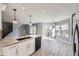 Open concept kitchen with gray countertops, stainless steel sink, and view of the dining area and backyard at 9605 Elk Mountain Cir, Littleton, CO 80125