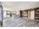 Open-concept living area featuring updated flooring and a stylish accent wall at 9605 Elk Mountain Cir, Littleton, CO 80125